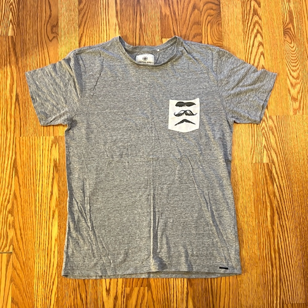 On the Byas mustache pocket tee